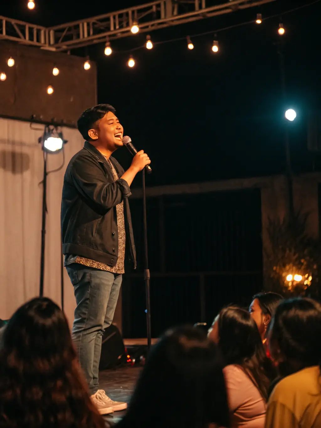 A compelling photograph of a spoken word poetry slam, capturing the emotion and power of the performances, showcasing the literary and performance aspects of the program.